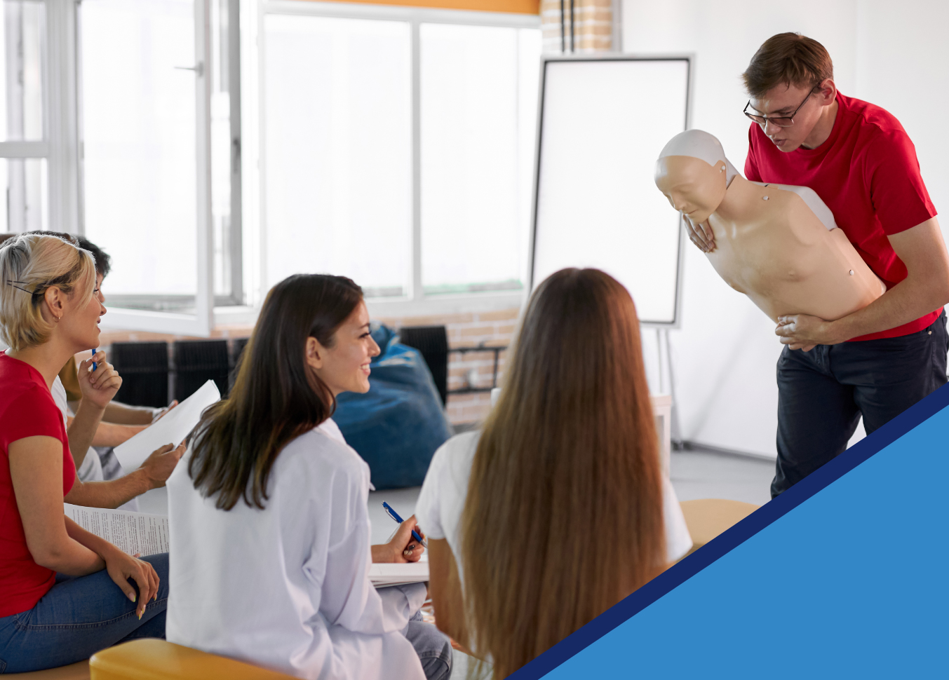 Pricing An instructor holding a CPR mannequin, demonstrating the heimlich maneuver to a small class of adults. Pricing is available for both individual and group classes.