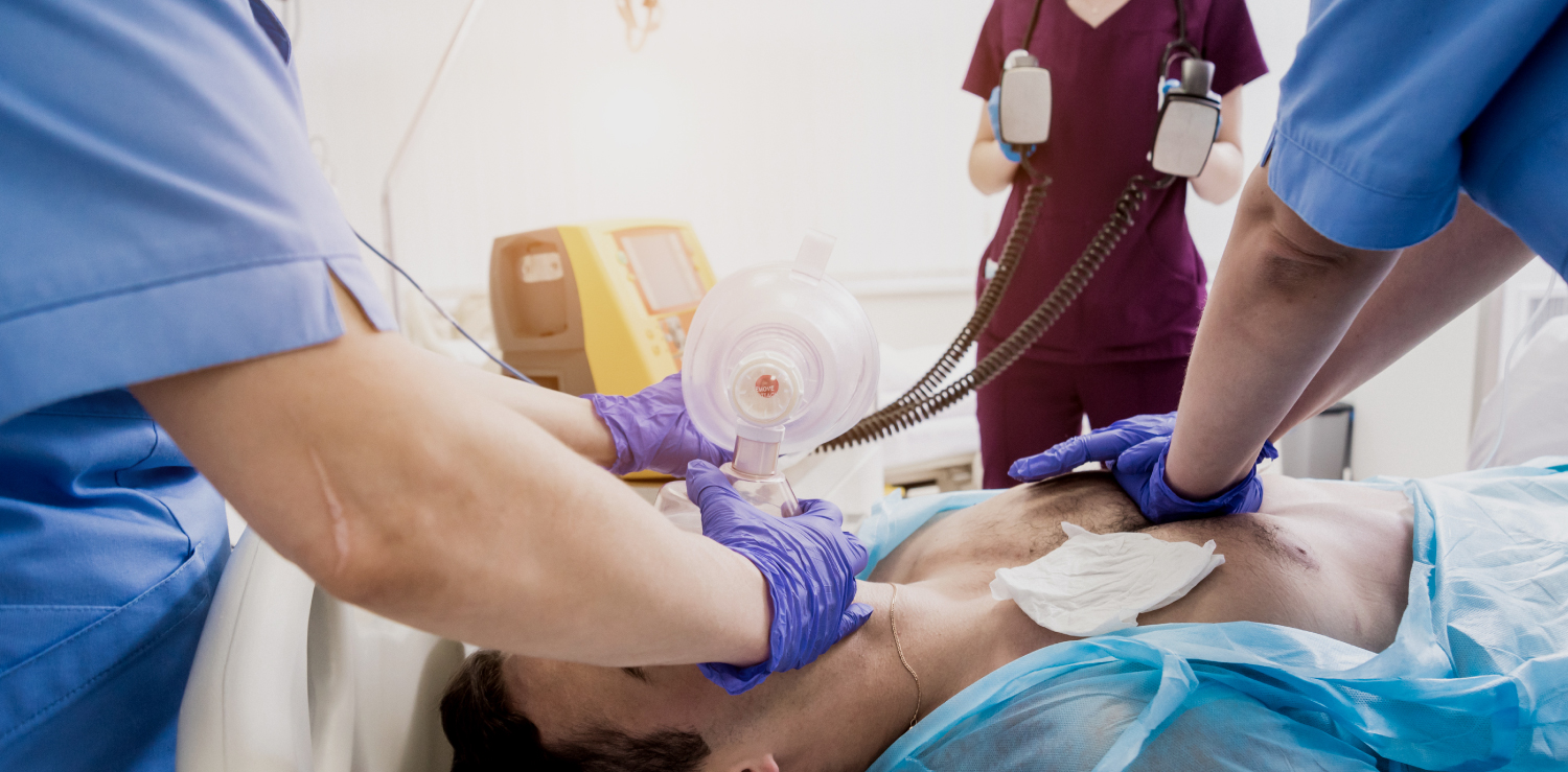 Advanced Cardiac Life Support (ACLS) Healthcare professionals performing advanced cardiac life support (ACLS) on a patient. A physician has an AED on standby while two others perform CPR.
