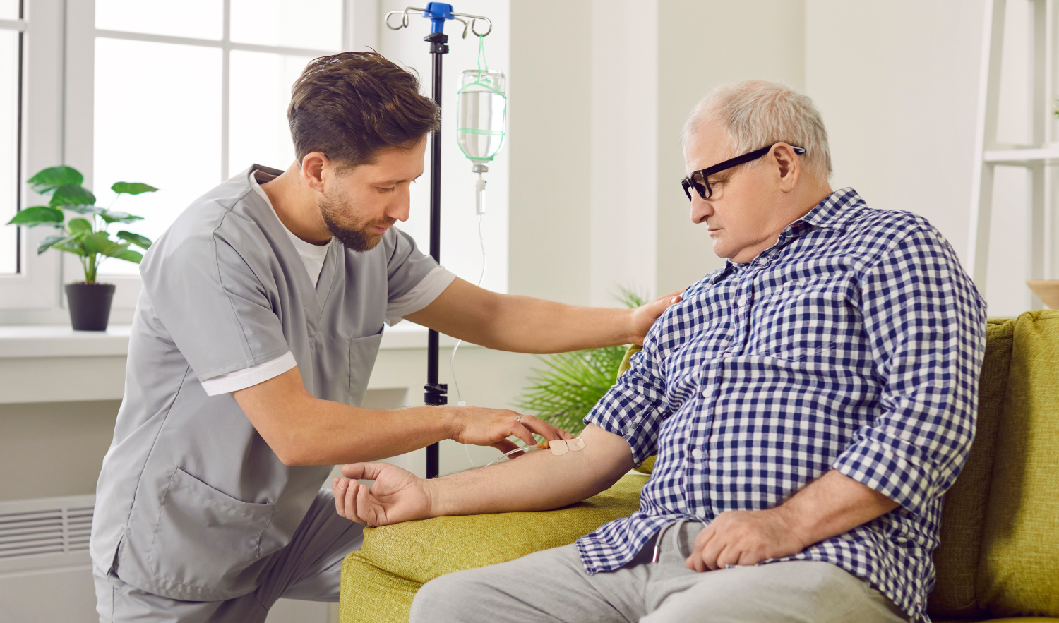 Vascular Access IV Training Medical professional administering an IV to an older gentleman.